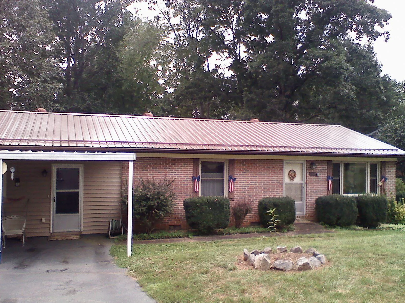 Bronze metal roof and carport on a brick ranch home — Roof Repair work by our crew in Schaefferstown