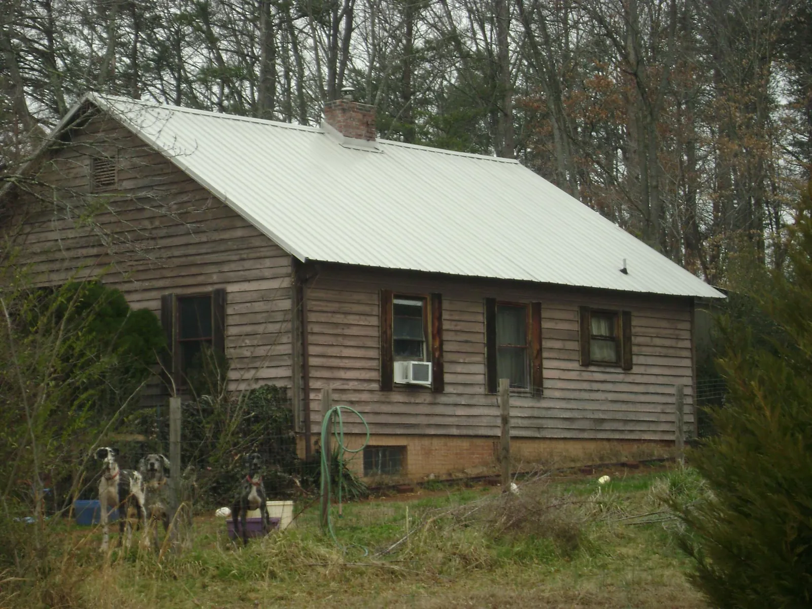 White metal roof on an old wood sided farmhouse, from a Metal Roof Installation job in Schaefferstown